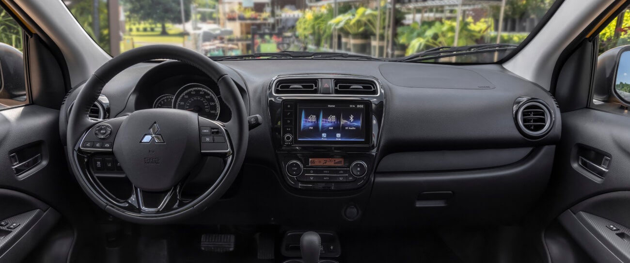 The steering wheel and dashboard in the 2024 Mitsubishi Mirage Compact Hatchback