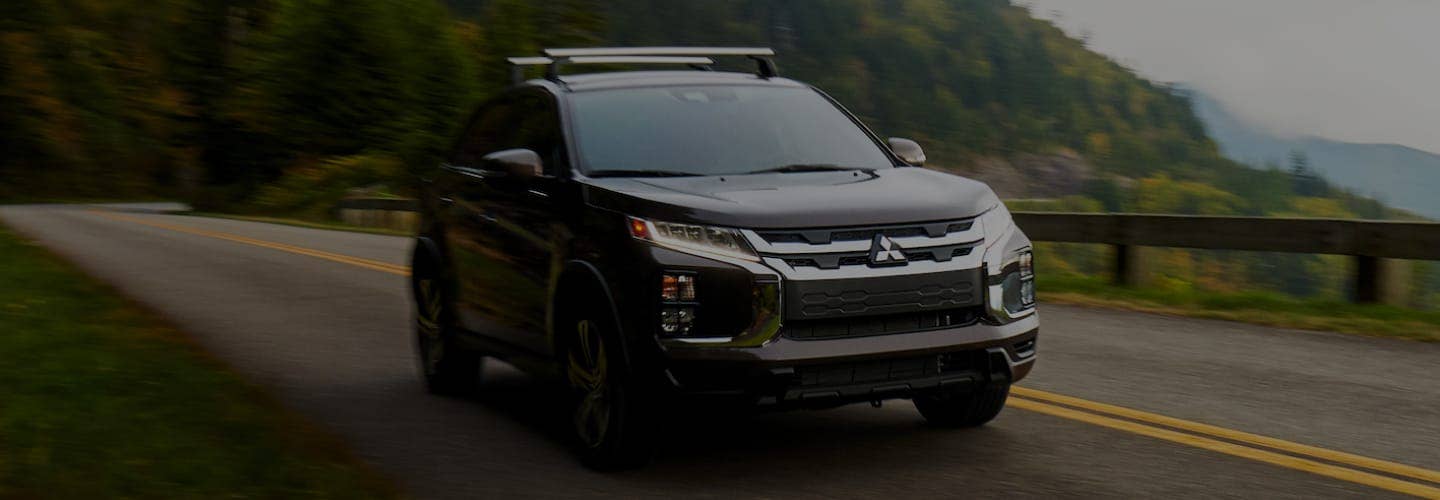 A silver Mitsubishi SUV with Super-All Wheel Control driving