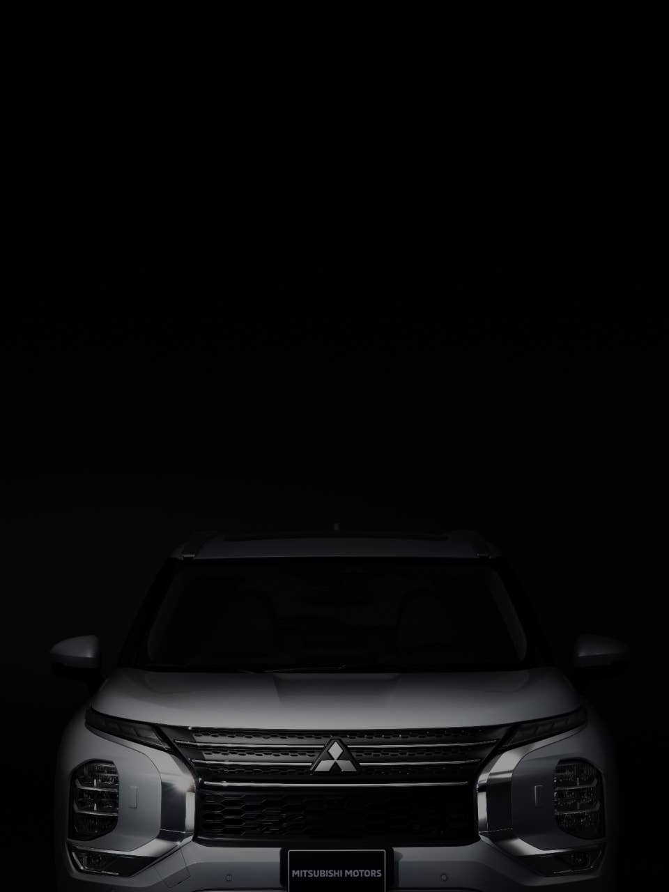 Front view of a white Mitsubishi Outlander SUV