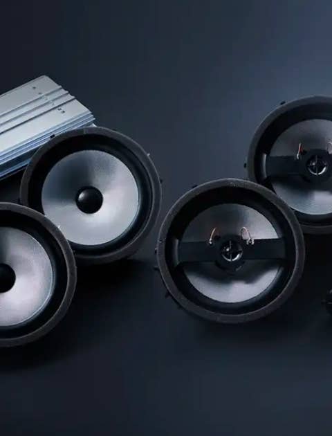 Four speakers from a 2023 / 2024 Mitsubishi Eclipse Cross Compact SUV deconstructed on a black background