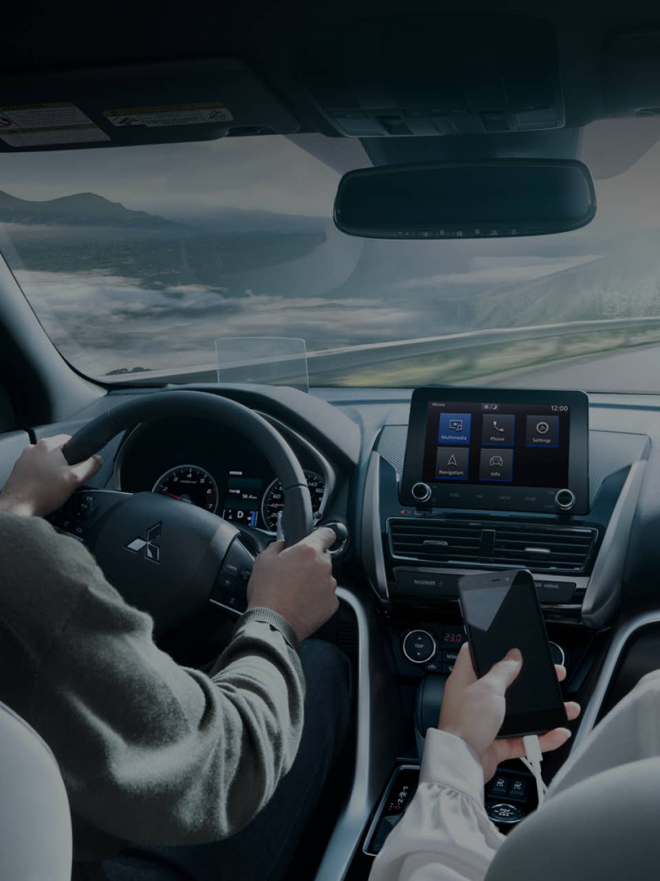Driver and passenger using the Connectivity features in the 2024 / 2025 Mitsubishi Eclipse Cross Compact SUV