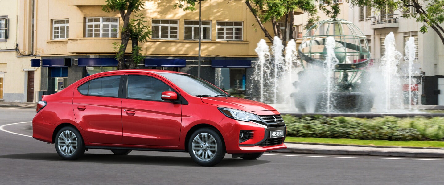 Side profile of an infrared Mitsubishi Mirage G4 driving on a roundabout