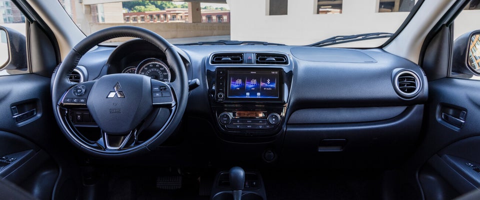 Close-up view of a 2022 & 2023 Mitsubishi Mirage G4 sedan steering wheel and dashboard