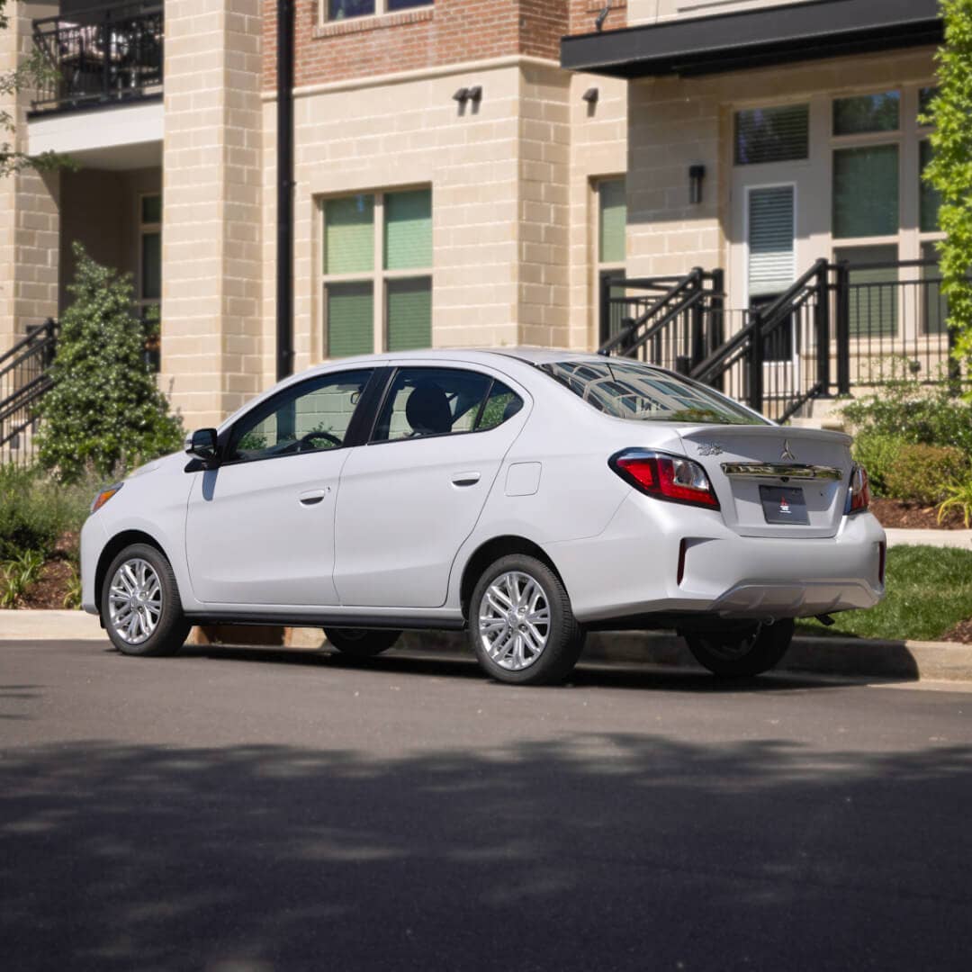 Rear angled view of a parked white 2022  & 2023 Mitsubishi Mirage G4