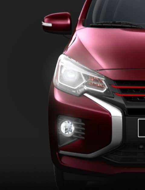 Headlights of a red wine metallic 2022 & 2023 Mitsubishi Mirage hatchback