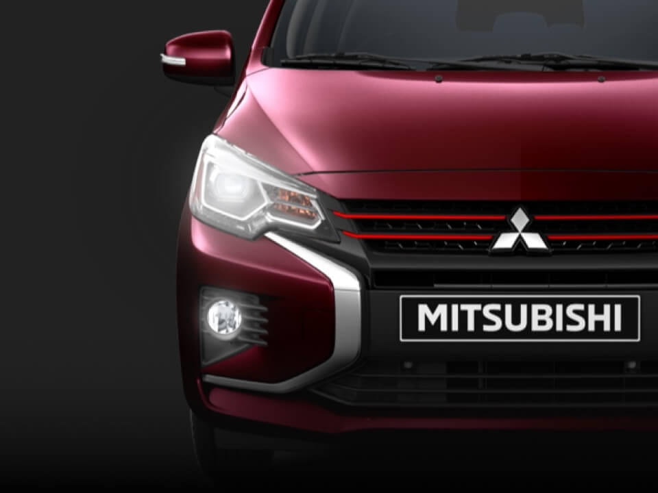 Headlights of a red wine metallic 2022 & 2023 Mitsubishi Mirage hatchback