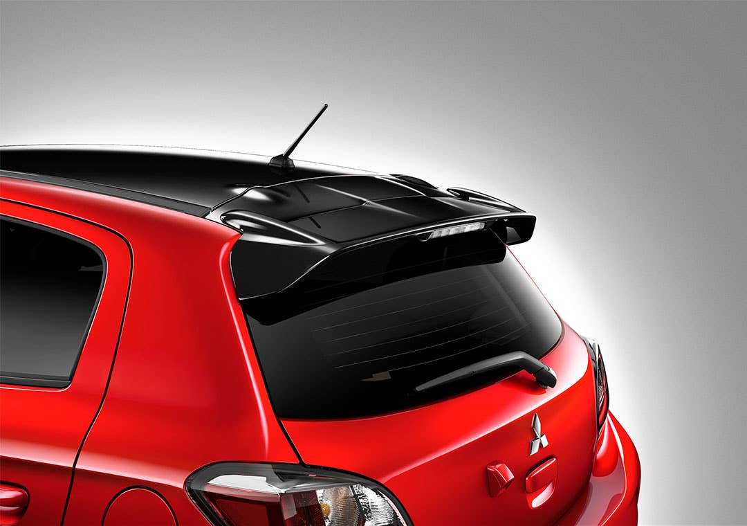 A red 2022 & 2023 Mitsubishi Mirage with a black spoiler