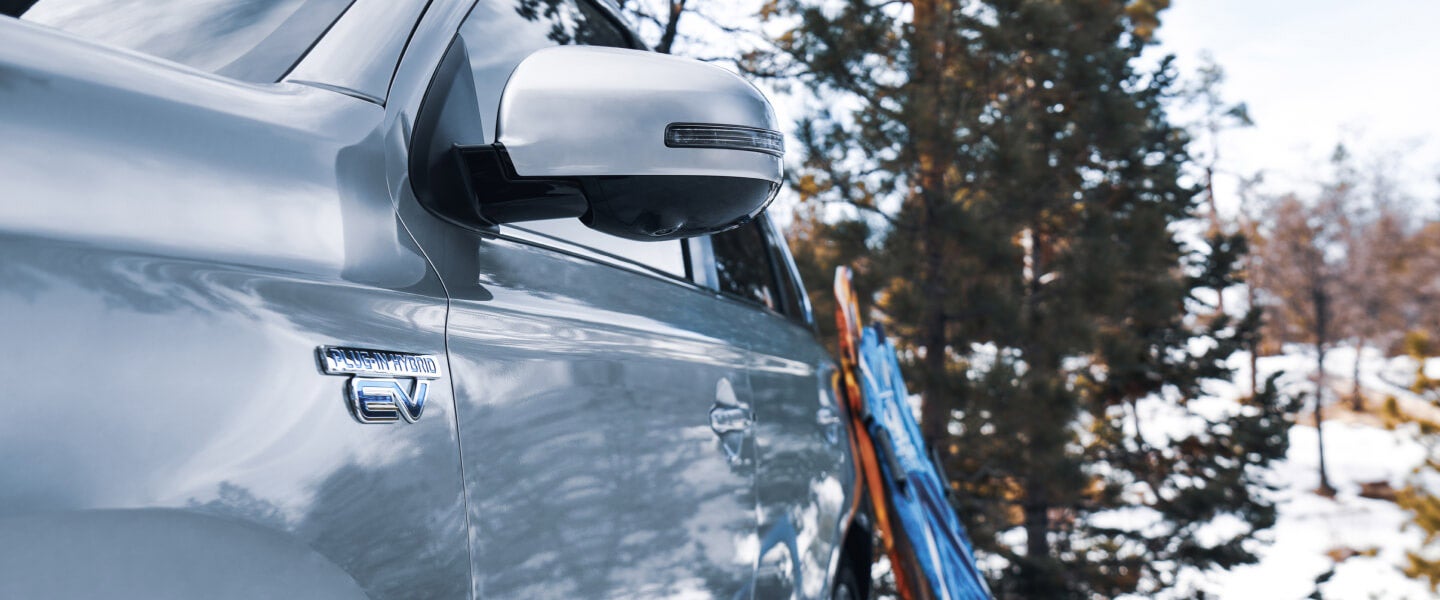 Snow boards resting on a 2022 Mitsubishi Outlander PHEV to demonstrate that it is capable to carrying big items