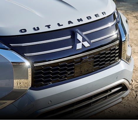 Close up on the front grille on a white 2026 Mitsubishi Outlander PHEV SUV