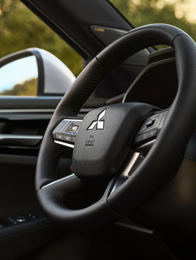 Close up on the heated steering wheel in the 2026 Mitsubishi Outlander PHEV SUV