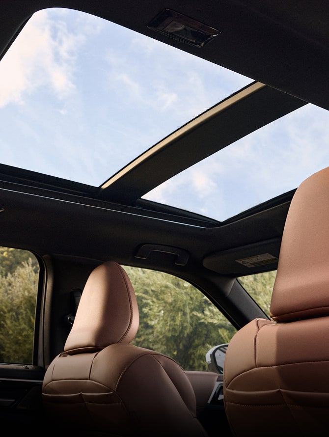 Angled view from the inside of a 2026 Mitsubishi Outlander PHEV SUV of the panoramic sunroof
