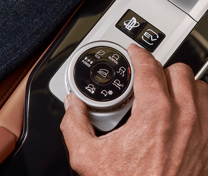 Close up on a hand turning the drive mode selector in the 2026 Mitsubishi Outlander PHEV SUV