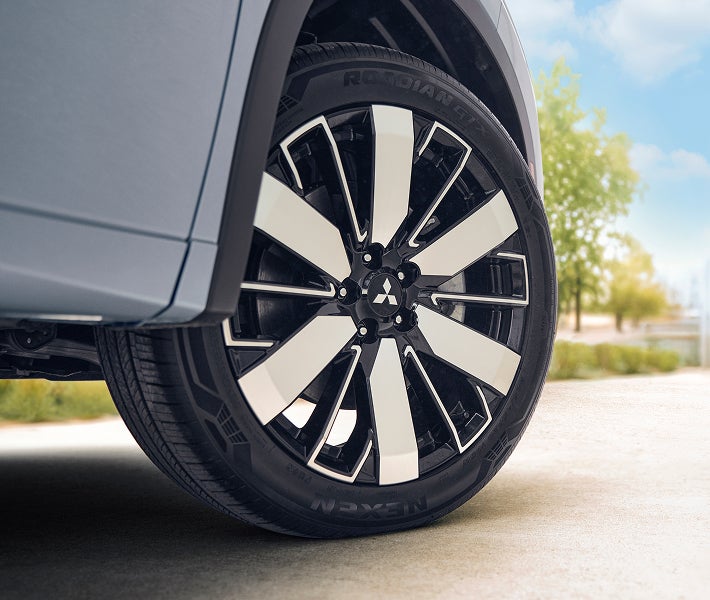 Close up on the wheels of a 2026 Mitsubishi Outlander PHEV SUV showing off Super All Wheel Control