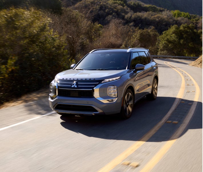 2026 Mitsubishi Outlander PHEV SUV driving on a highway