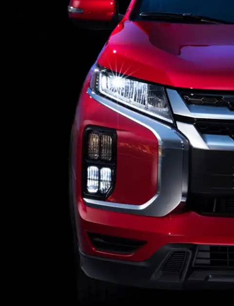 A red 2023 Mitsubishi Outlander Sport SUV LED headlight
