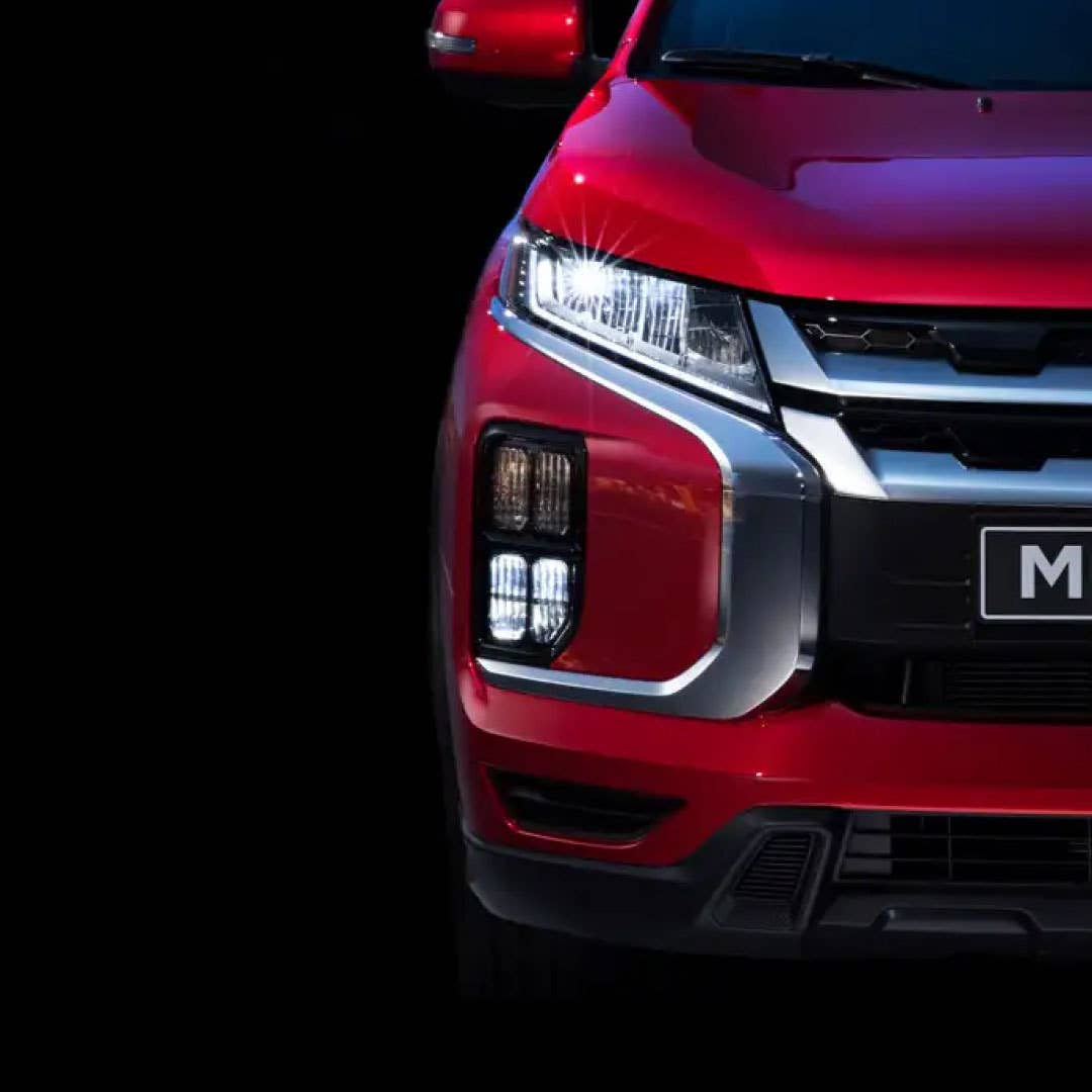 A red 2023 Mitsubishi Outlander Sport SUV LED headlight