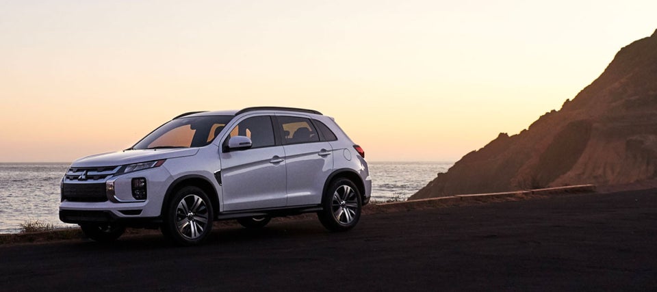 A white 2024 Mitsubishi Outlander Sport SUV parked on the beach
