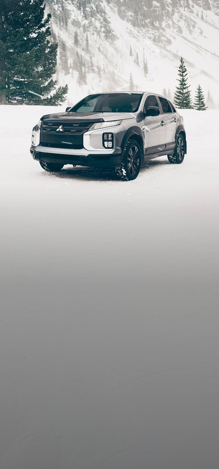A silver 2025 Mitsubishi Outlander Sport SUV in the snow