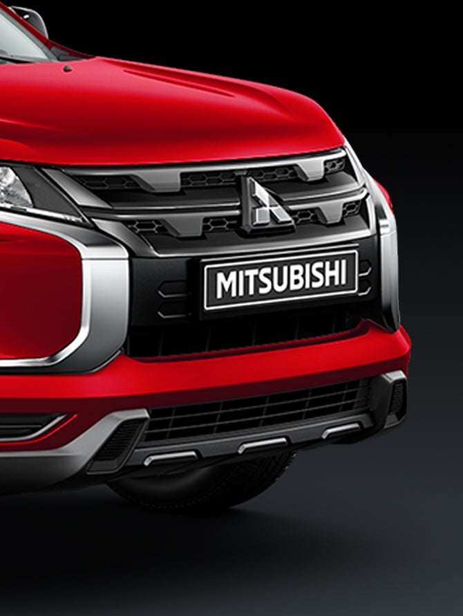 Close up on a red 2026 Mitsubishi Outlander Sport SUV front grille