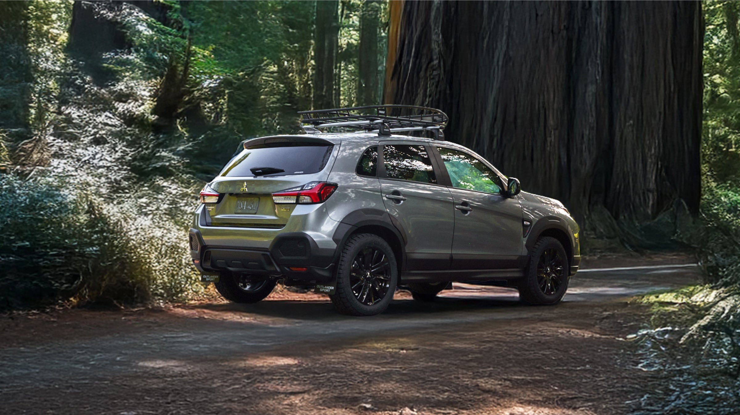 2027 Mitsubishi Outlander Sport Trail Edition parked on a dirt road in a forest