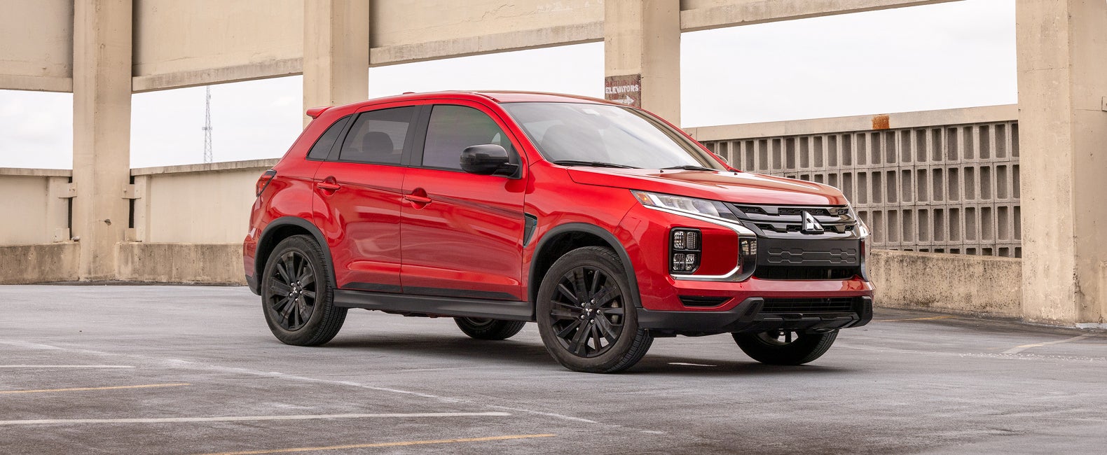 Angled view of a red 2027 Mitsubishi Outlander Sport small crossover SUV