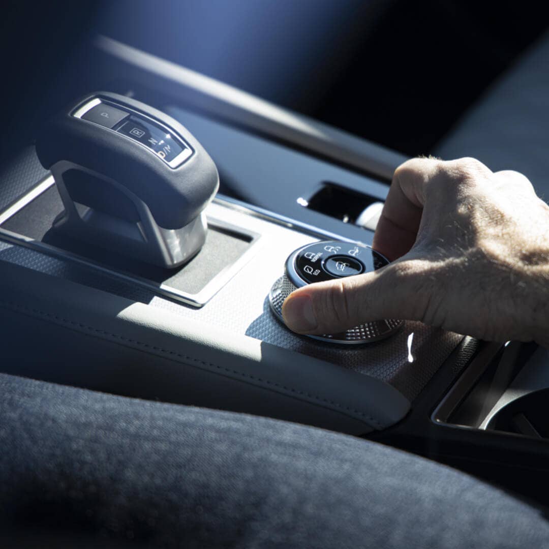 Driver changing the driver mode on the 2022-2023 Mitsubishi Outlander SUV