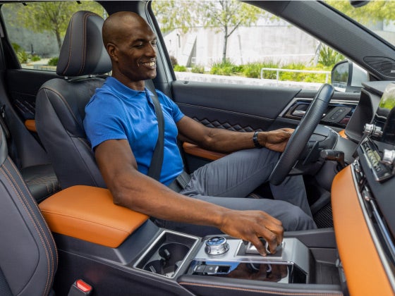 Top view of a man driving the 2022 & 2023 Mitsubishi Outlander SUV