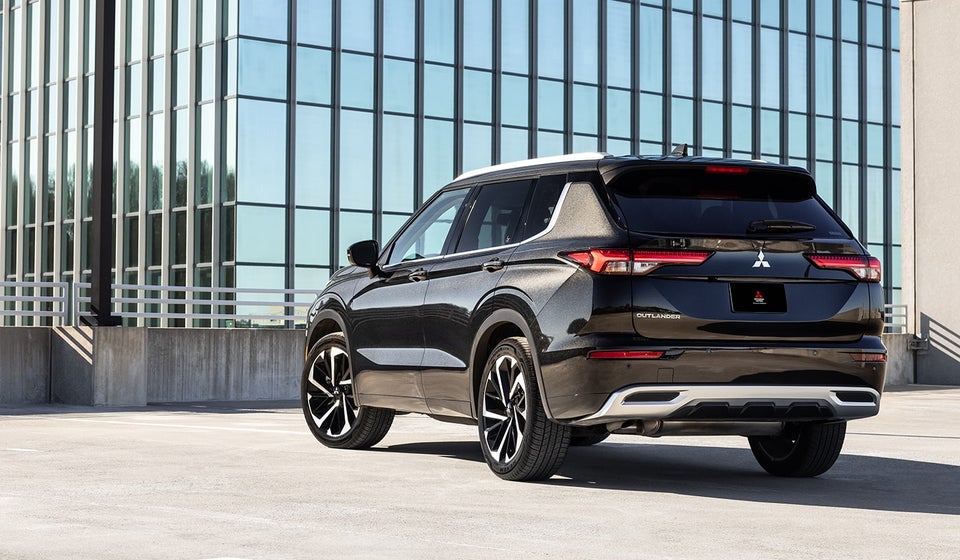 Angled back view of a black 2024 Mitsubishi Outlander SUV