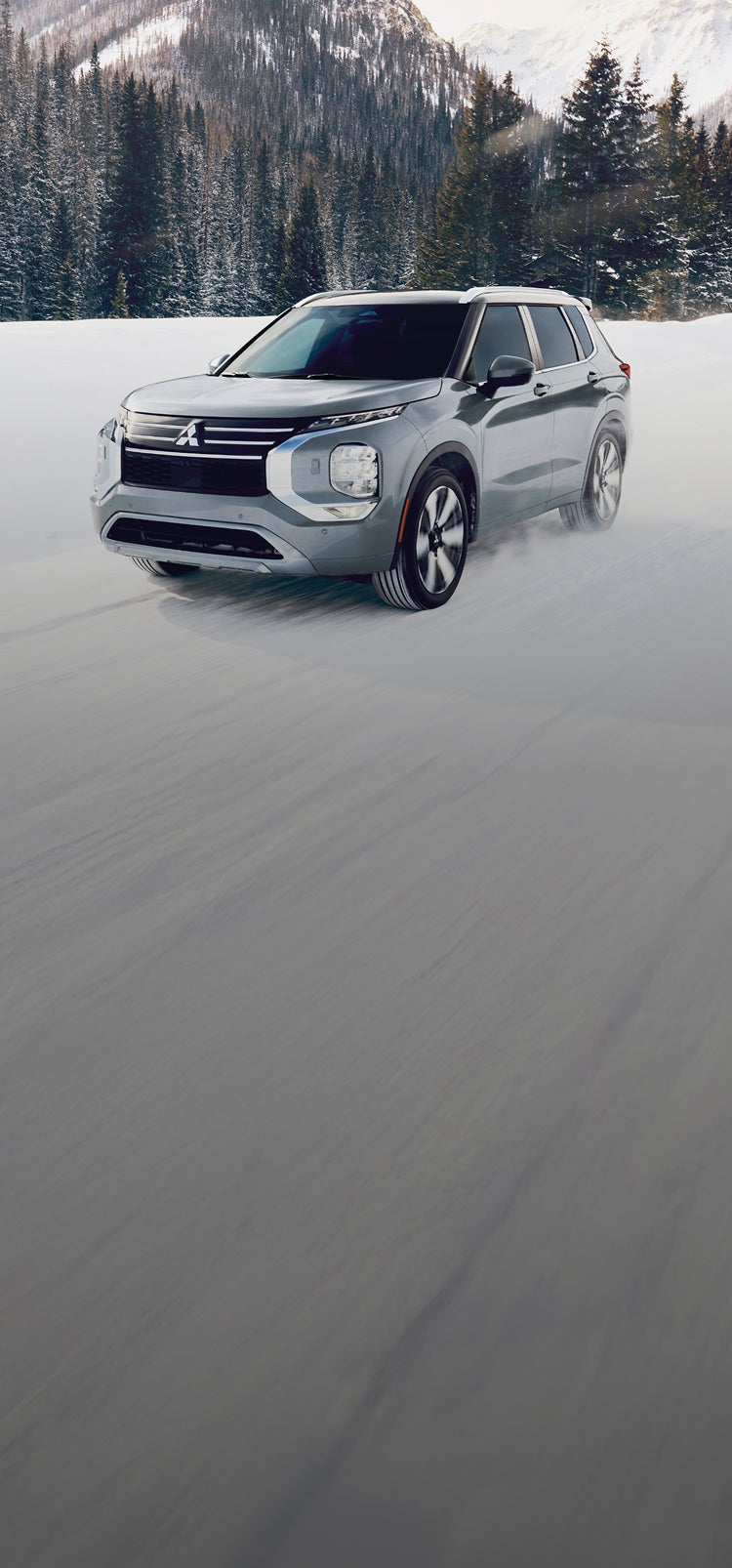 A silver 2025 Mitsubishi Outlander SUV in the snow