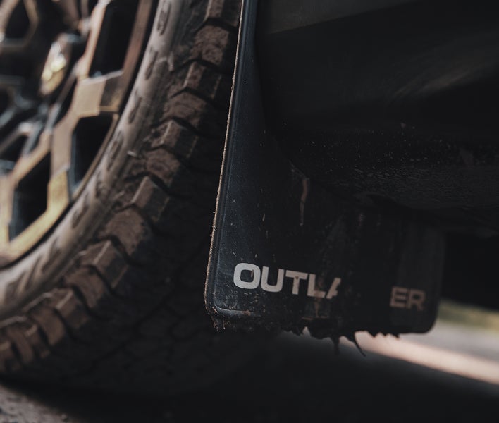 2025 Mitsubishi Outlander Trail Edition SUV with mud flaps