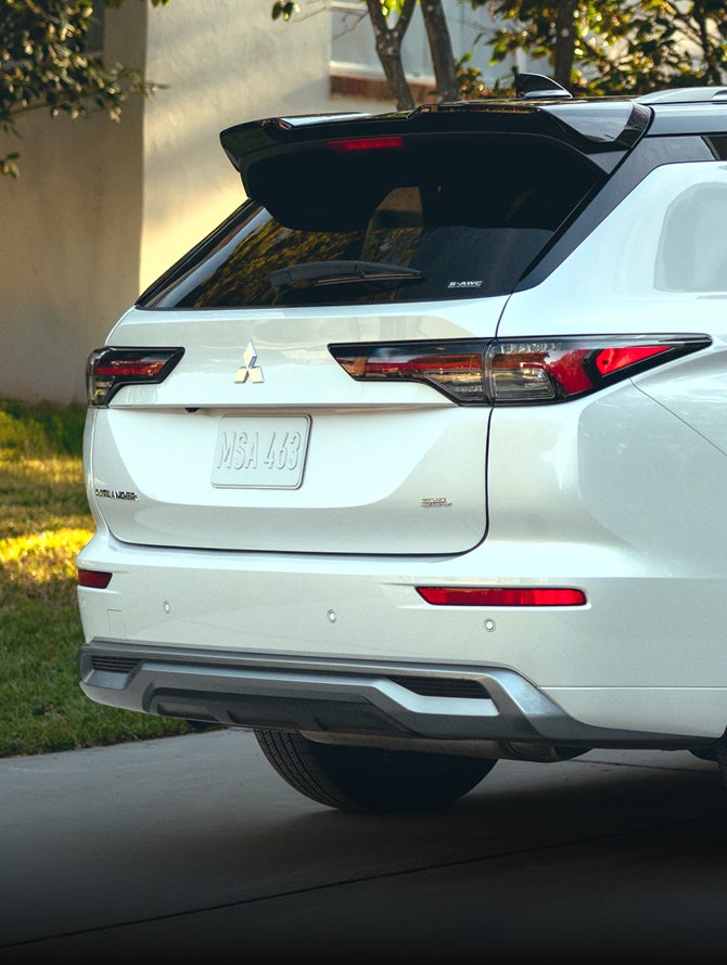 View from behind of a white 2026 Mitsubishi Outlander SUV to show off the LED taillights
