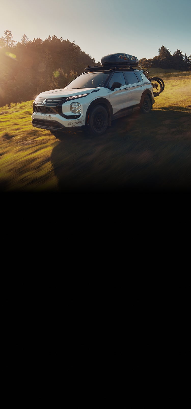 2026 Mitsubishi Outlander SUV Trail Edition driving in a field